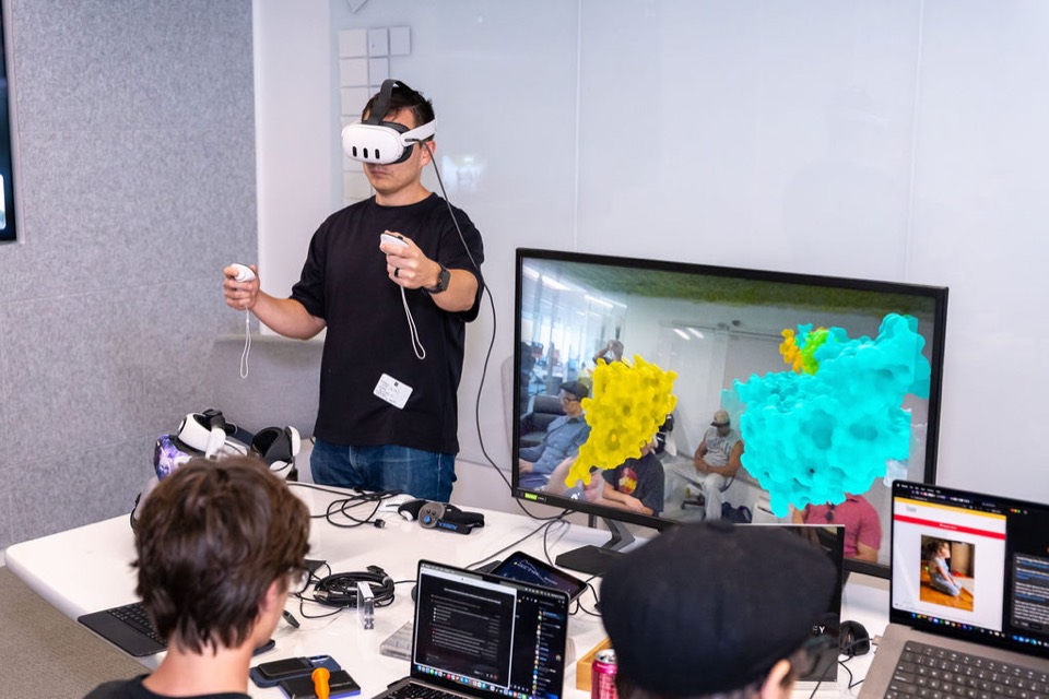 Alpha Team member demonstrating interactive 3D molecular visualization in virtual reality during Golden Hour 006